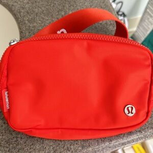 Orange Lululemon Everywhere Belt Bag.